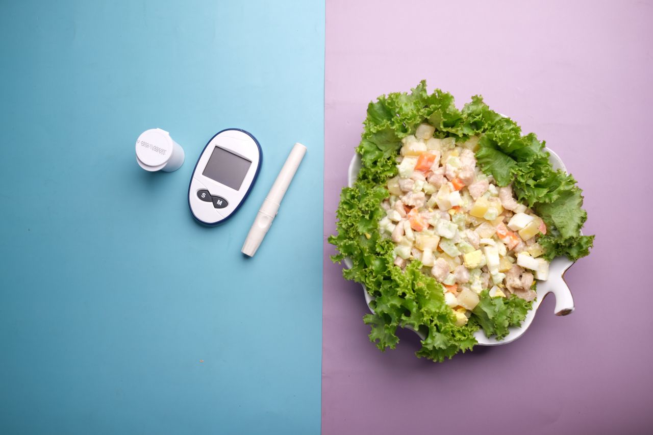who-we-are Top view of diabetes equipment and fresh salad representing healthy living.