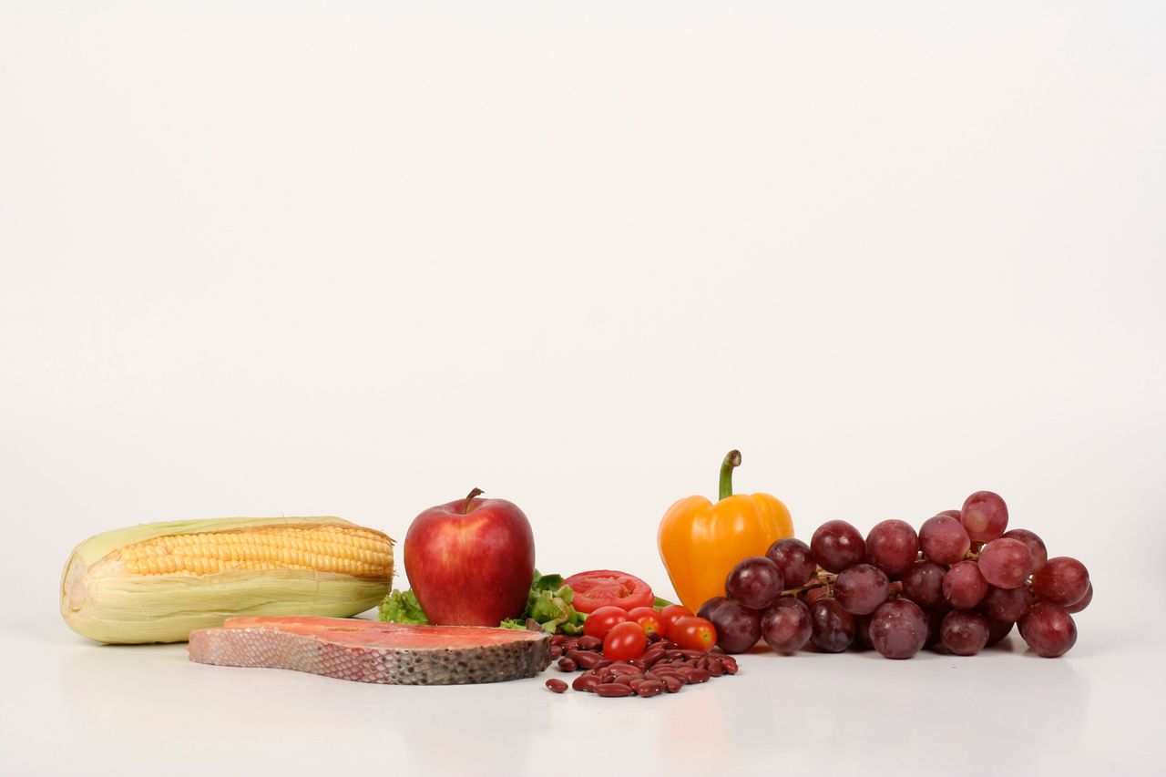 services-01 Vibrant display of fruits, vegetables, and salmon on a white background, ideal for food and health themes.